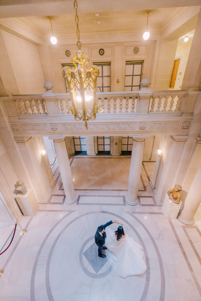 Anh and Tuan dancing beneath the City Hall rotunda