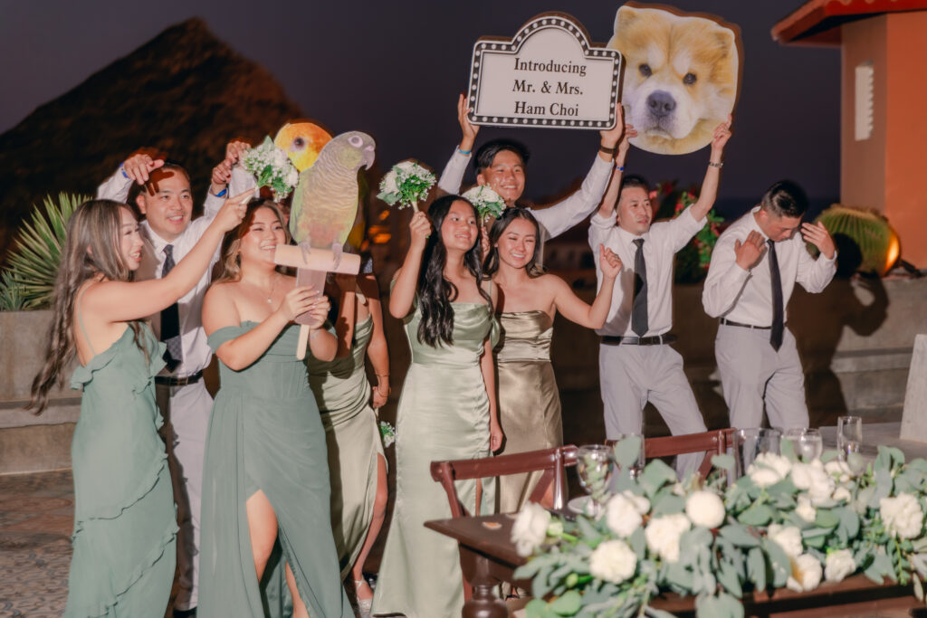 The wedding party announcing newlyweds with fun signs