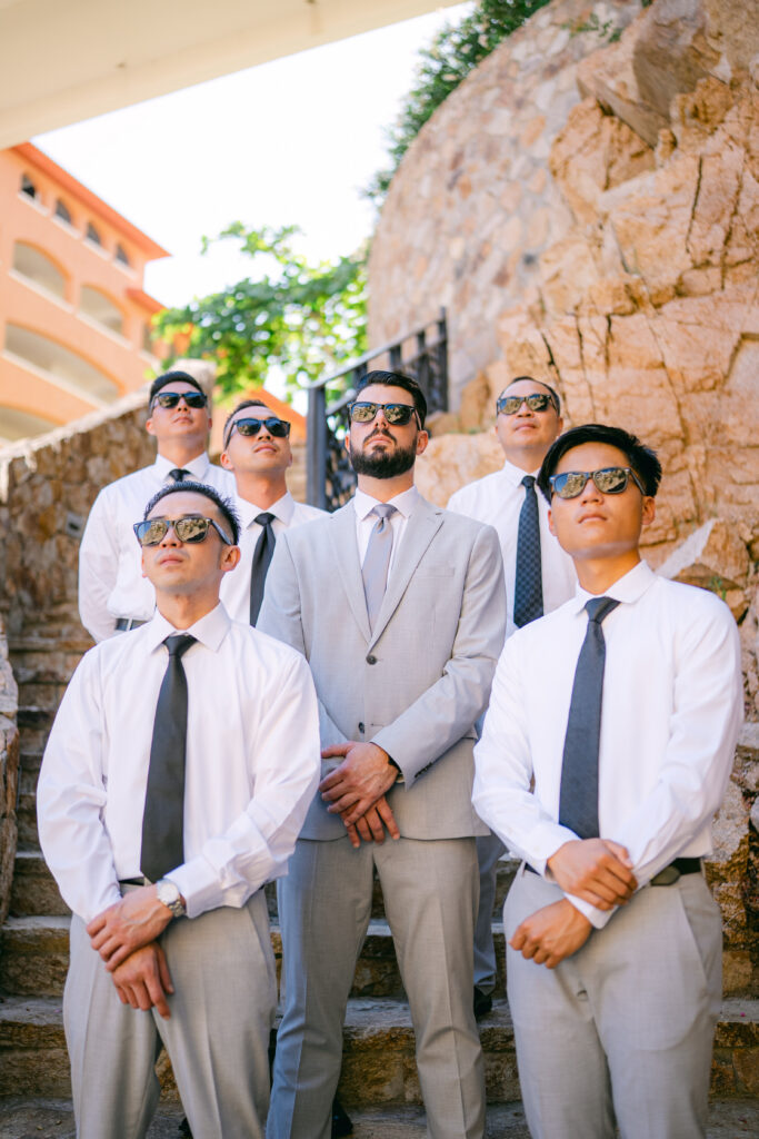 Chris and his groomsmen in sunglasses posing on Sandos Finisterra steps