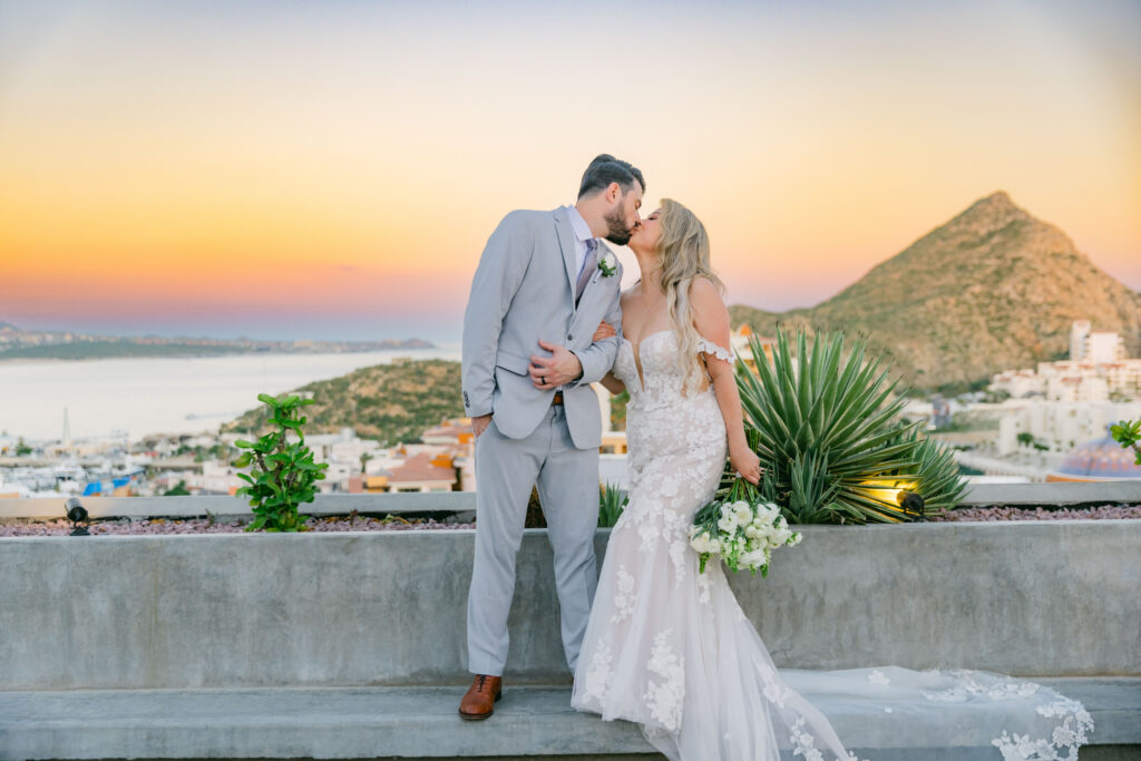 Chris and Jennifer kissing at sunset