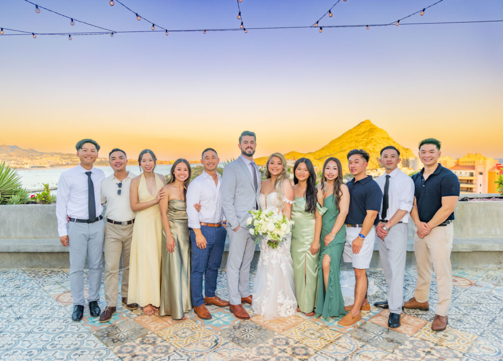 Jennifer, Chris, and loved ones with a Cabo San Lucas sunset in the background