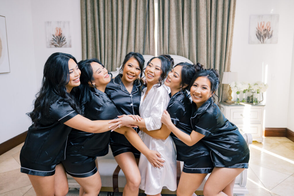 Jocelyne and her bridesmaids smiling together while getting ready