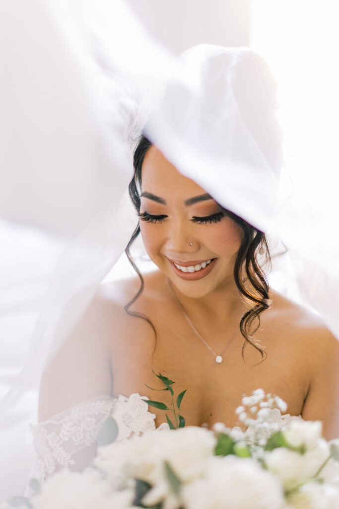 Jocelyne smiling beneath her veil before the ceremony
