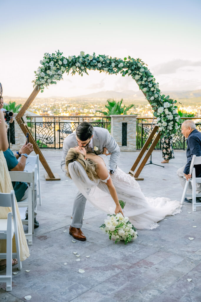 Chris dipping Jennifer for their first kiss at the altar