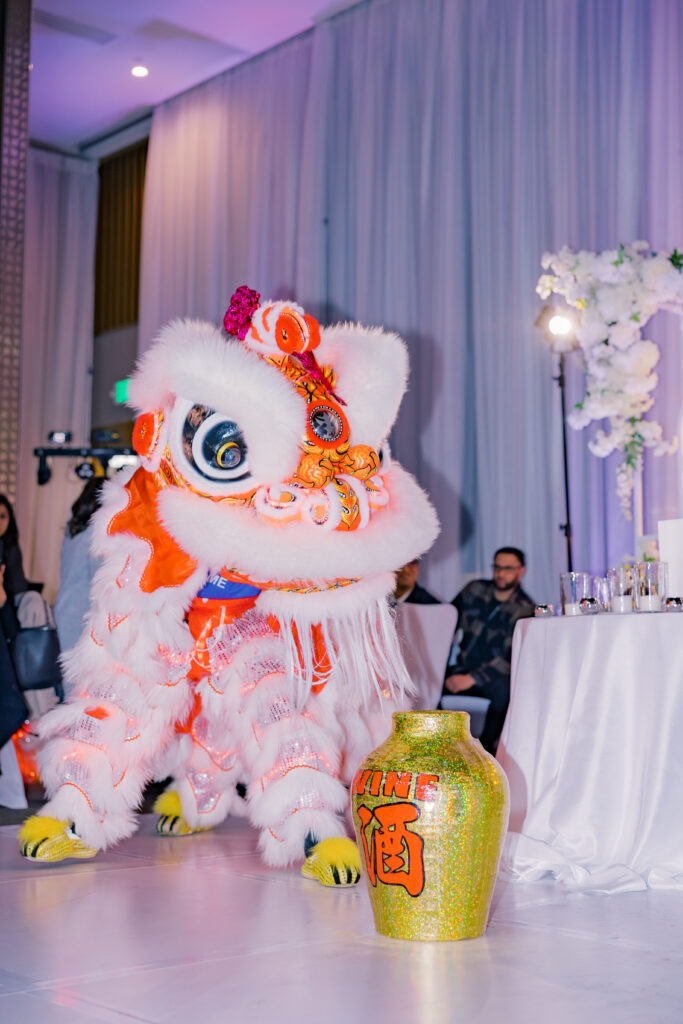 A lion dancer performing at the reception