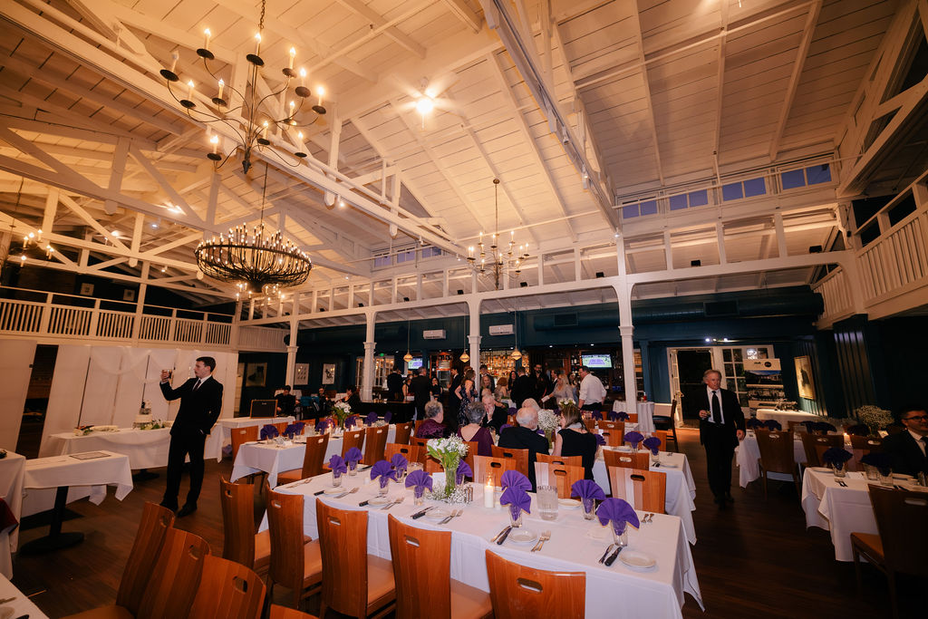 MacArthur Park reception room with guests and chandeliers