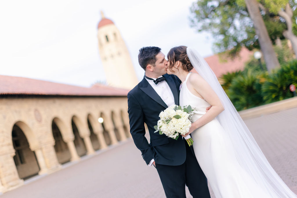 Makenna and Nicholaus kissing with Stanford in the background