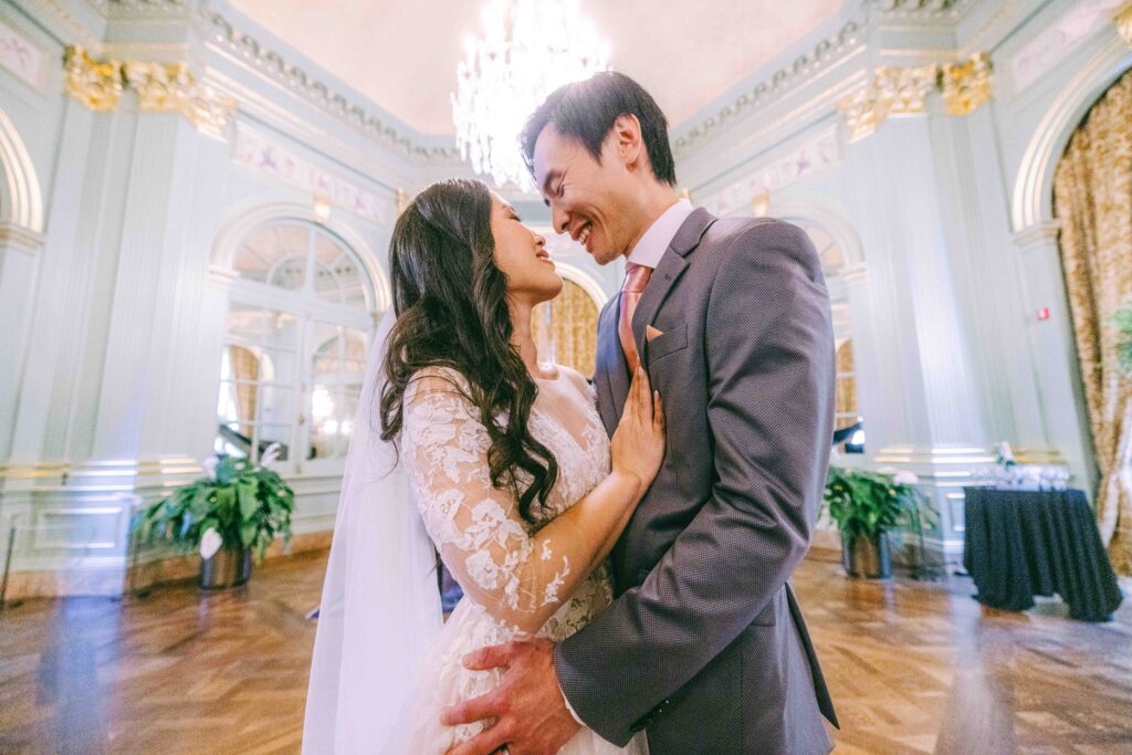 Monica and Kevin laughing together in the Filoli ballroom