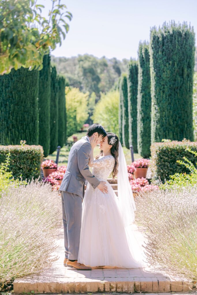 Monica and Kevin in the Filoli formal garden with cypress trees