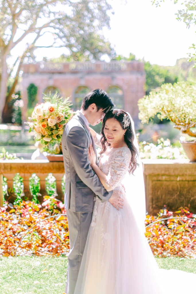 Monica and Kevin embracing in the Filoli rose garden