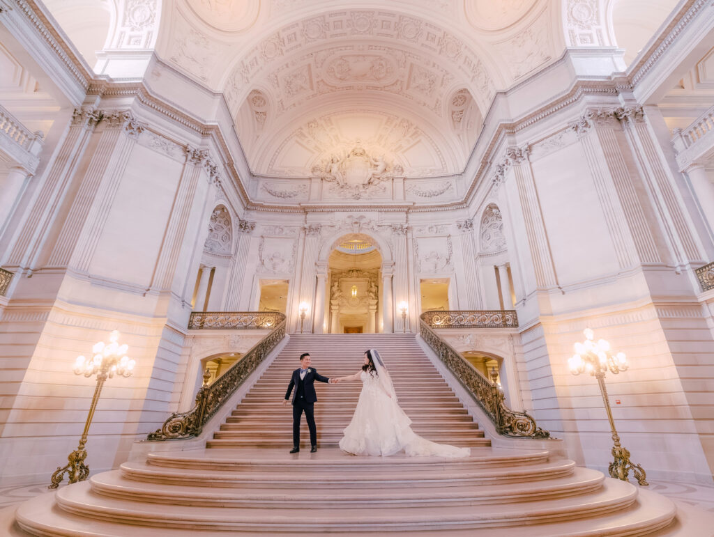 Casey and Minh holding hands at their San Francisco City Hall wedding